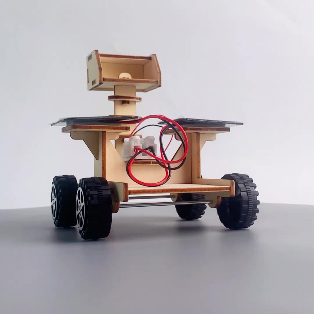 Multiple views of the assembled wooden solar-powered lunar rover toy.