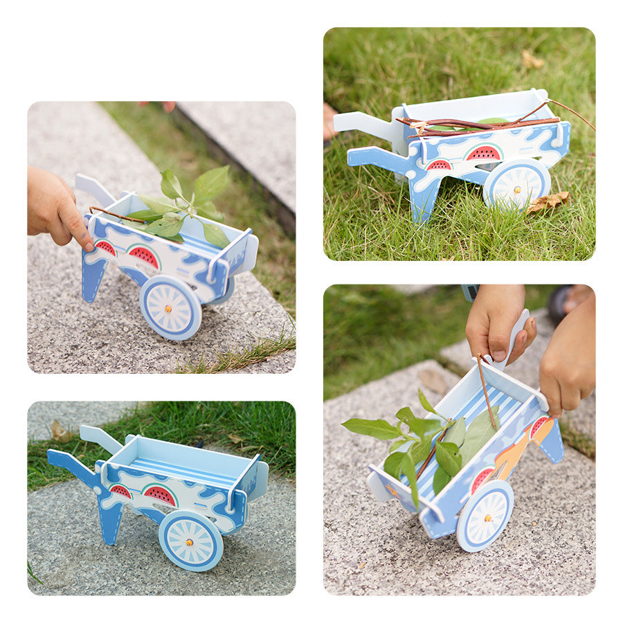 Completed DIY Handcart Toy: A small, colorful cardboard wheelbarrow with watermelon and star decorations, ready for imaginative play.