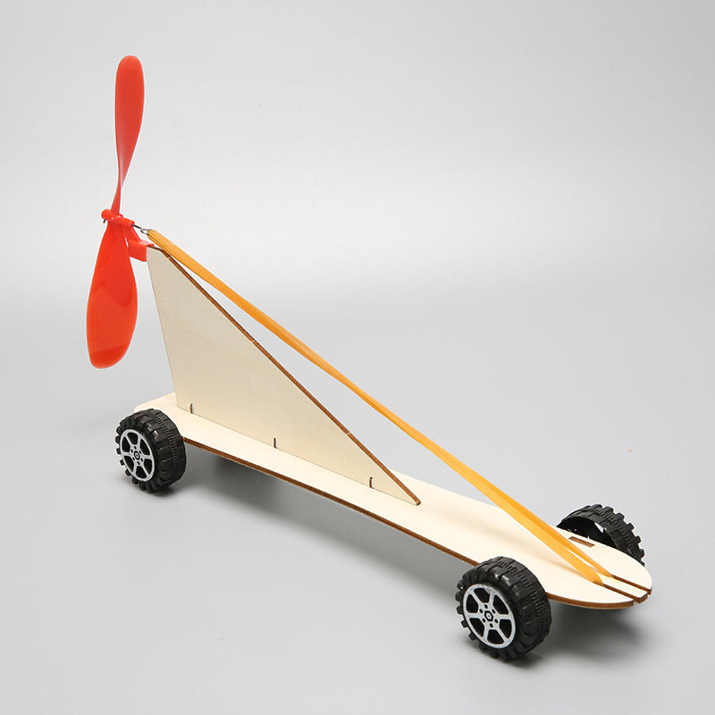 Top view of the assembled DIY Rubber Band Powered Car Kit, highlighting its wooden structure and propeller.