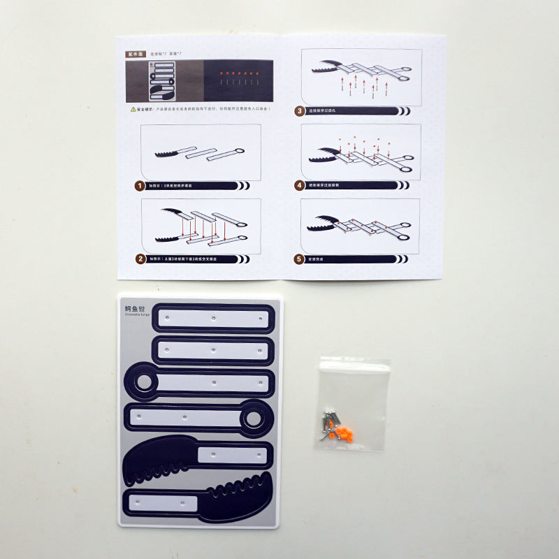 DIY Alligator Clip Kit contents: pre-cut cardboard sheets, orange connectors, and instruction manual.