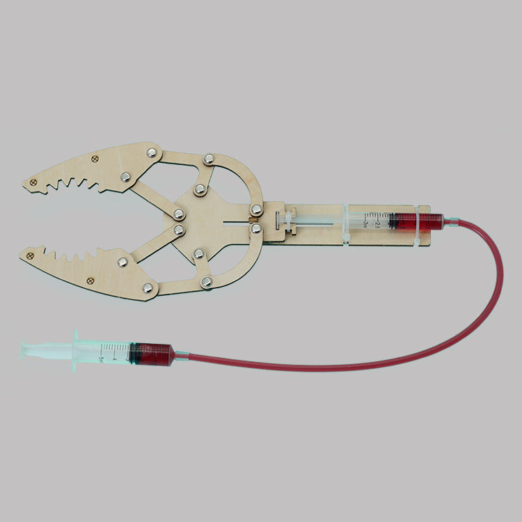 Assembled DIY Hydraulic Manipulator Kit, showcasing wooden components and syringe mechanism.