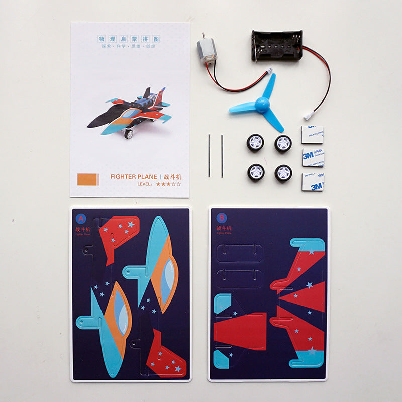 Unassembled DIY Fighter Jet Kit contents: cardboard pieces, motor, propeller, wheels.
