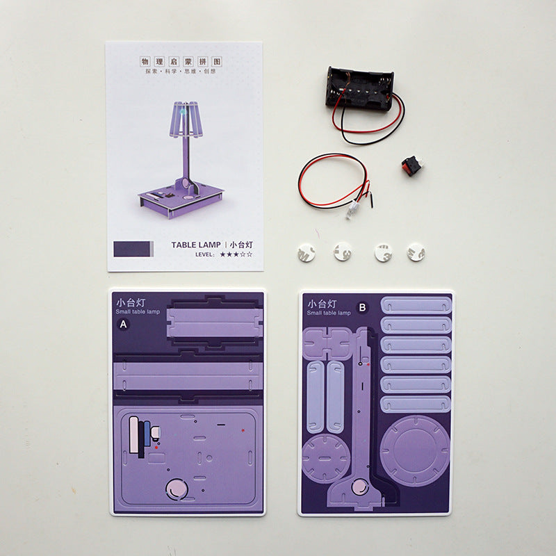 DIY Desk Lamp Kit contents: pre-cut cardboard, electronic parts, and instructions.