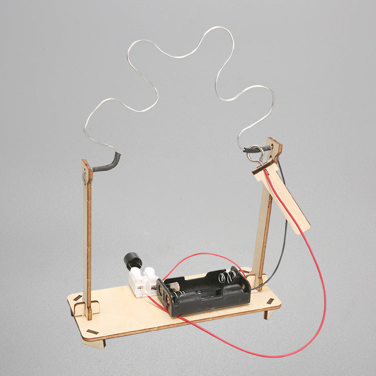 Close-up of the metal maze wire and conductive loop in the DIY CrossFire Kit, illustrating the challenge of the electromagnetic game.
