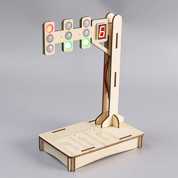 Close-up of the fully assembled DIY Traffic Light Kit, highlighting the wooden structure, LED lights, digital '8' display, and base with road markings.