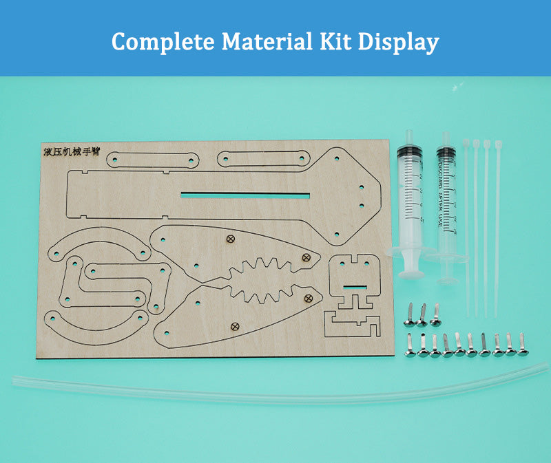 Complete set of parts for the DIY Hydraulic Manipulator: laser-cut wood, syringes, ties, and tubing.