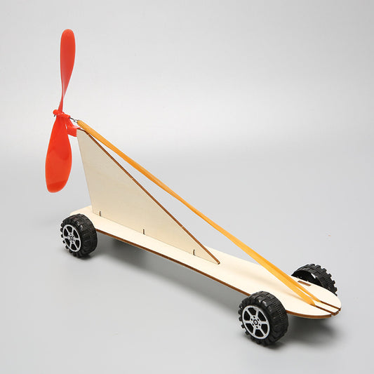Top view of the assembled DIY Rubber Band Powered Car Kit, highlighting its wooden structure and propeller.