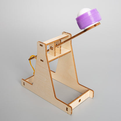 Close-up of the assembled wooden DIY Catapult Kit, showing its mechanism.