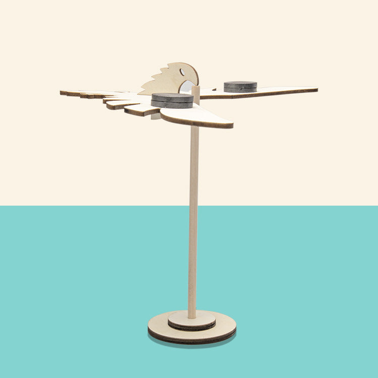 Finished DIY wooden balancing bird with magnetic weights, ready to balance.