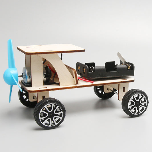 Assembled DIY wind powered car kit, showcasing wooden frame, propeller, wheels, and battery box with dimensions (150x70x80mm).