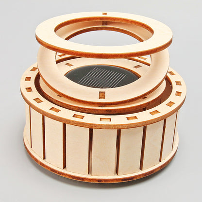 Assembled DIY Solar Double Ring Kit, a wooden educational toy powered by the sun.