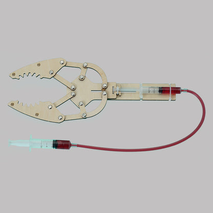Assembled DIY Hydraulic Manipulator Kit, showcasing wooden components and syringe mechanism.