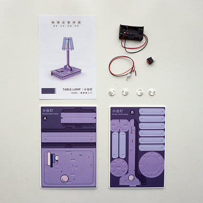 DIY Desk Lamp Kit contents: pre-cut cardboard, electronic parts, and instructions.