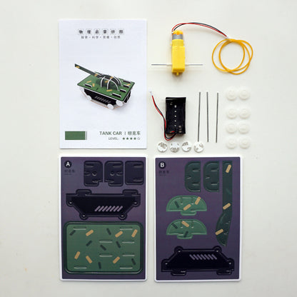 Open DIY Tank Kit showing all included components: cardboard tank parts, motor, battery pack, wheels, axles, rubber bands, and manual.