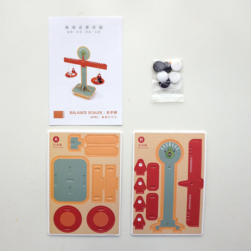 Unboxing the DIY Balance Scale Kit: Pre-cut cardboard sheets and balance weights included for kids' science project.