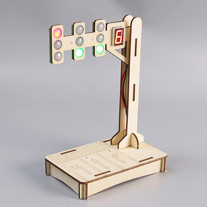 Close-up of the fully assembled DIY Traffic Light Kit, highlighting the wooden structure, LED lights, digital '8' display, and base with road markings.