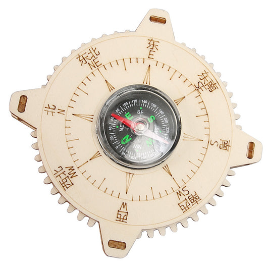 The fully assembled DIY wooden compass, a functional educational toy, displayed on a wooden surface.