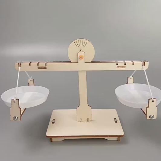 DIY Wooden Balance Scale Kit assembled, showing the educational toy for learning about levers and equilibrium, perfect for kids aged 3+