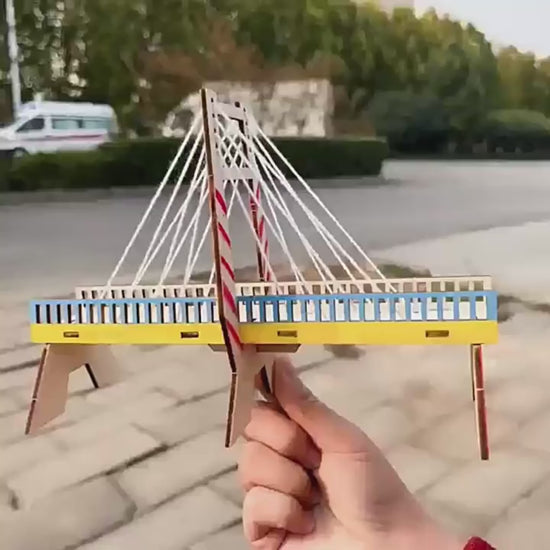 Kids building DIY cable-stayed wall kit, showing step-by-step assembly and finished structure.