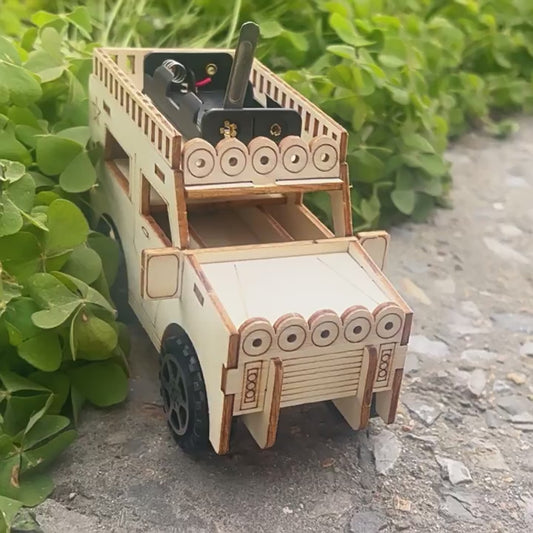 DIY Steel Jeep Kit assembly: Wooden parts, wheels, motor, and instructions laid out.